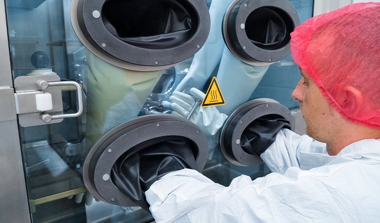 Operator at Gerteis ULTRA-PACTOR isolator glove ports